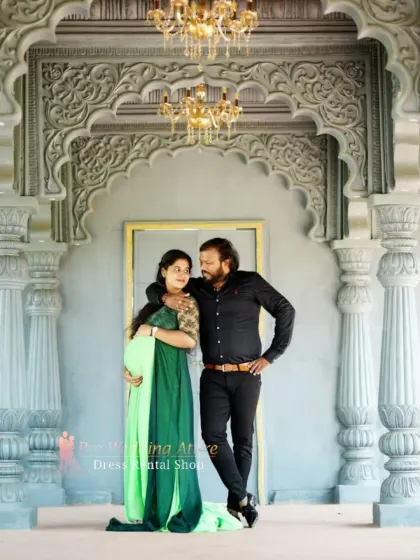 An intimate shot of a couple during their maternity shoot, with the expecting mother in our emerald and lime green gown. This rental dress is perfect for both grand, dramatic poses and quieter, close-up moments.