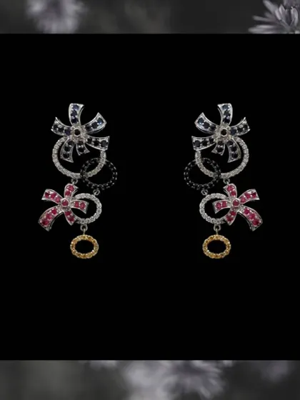 A clearer view of the multi-gemstone bow earrings. The mix of colors and shapes makes them a unique piece that will surely capture everyone's attention.