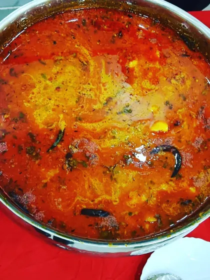 A close-up of a rich and flavorful vegetable curry, slow-cooked with a blend of aromatic spices. This is the kind of hearty main course that guests love.