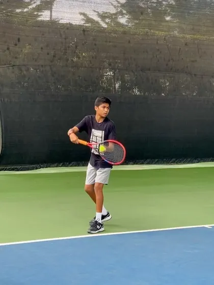 Yashas in action, preparing to serve during a match. This focus and technique are honed through countless hours of dedicated practice at our academy.