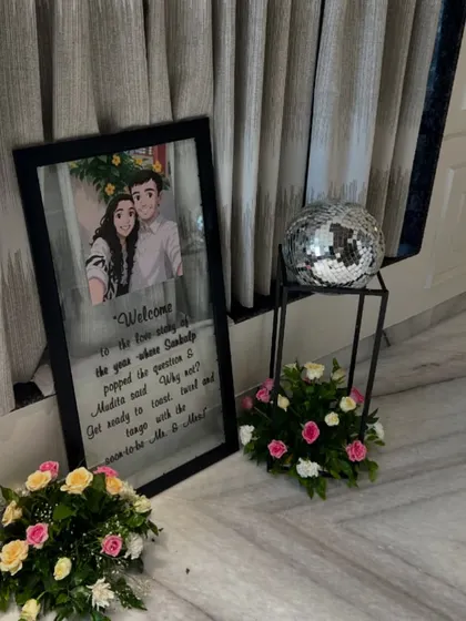 A personalized welcome sign with a caricature of the couple, placed at the entrance of a home for a pre-wedding event. It's these small details that make a celebration unique.