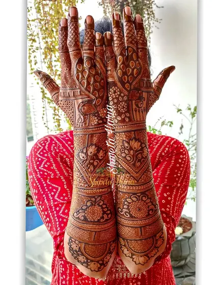 A beautiful example of a heavy Indian back-hand design. This style provides full coverage with a stunning mix of peacocks, florals, and meenakari-style bold patterns.