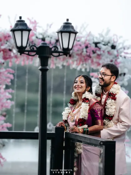 A beautiful outdoor portrait of the engaged couple. The floral arch and lakeside setting create a stunning and romantic backdrop.