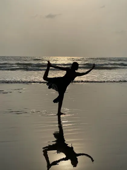 The reflection of this Dancer's Pose on the wet sand looks like a watercolor painting. It’s a beautiful capture of a New Year's moment in Goa, celebrating new beginnings with balance and grace.