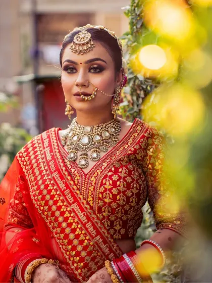 A lovely outdoor shot with beautiful bokeh. The bride's makeup, with its glittery eyes and flawless base, looks stunning in the natural light.