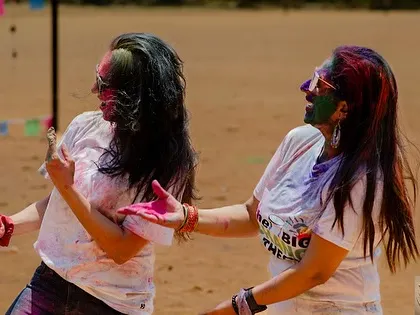 Sharing a dance moment with a fellow participant. It's all about interaction and shared joy, which is the core of any festival celebration.