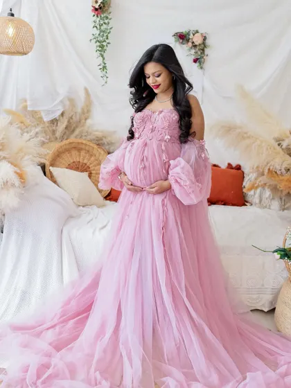 A duplicate of image 257, this beautiful portrait in a pink gown is set in a romantic, boho-inspired studio.