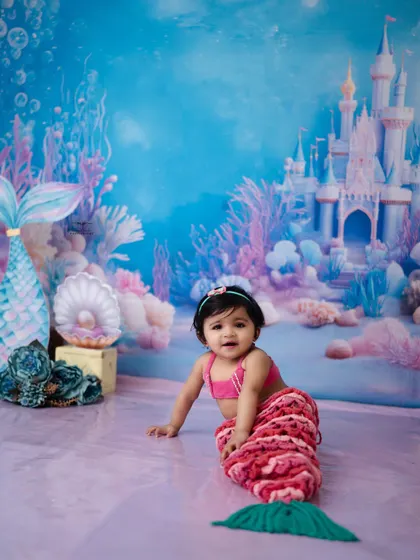 A full-length portrait of our crawling mermaid, complete with a sparkling tail. I provide a variety of costumes to make your child's fairytale dreams come true.