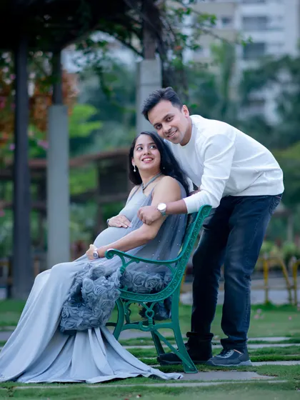 Using park benches and other elements helps create a variety of poses. This relaxed portrait captures a sweet, candid interaction between the couple.
