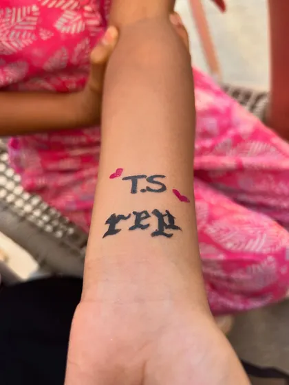 We even do themed temporary tattoos! This "T.S. Rep" arm art was a must-have for the Swifties at the party.