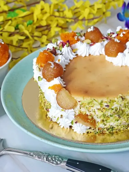 A beautifully styled shot of a Gulab Jamun fusion cake, combining traditional Indian sweets with modern baking. This type of creative food photography is great for bakeries and sweet shops wanting to highlight their unique menu items.