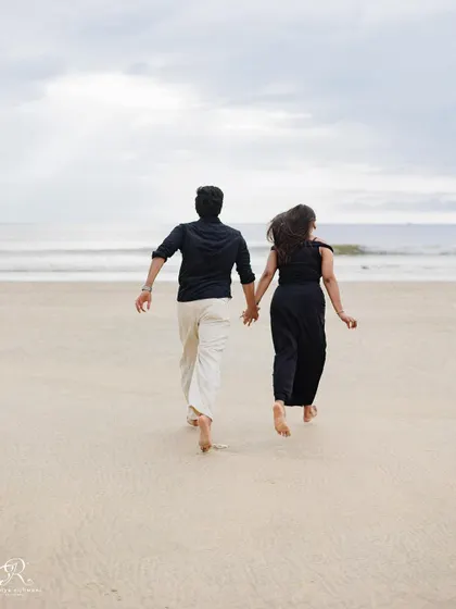 Running towards the ocean together, hand in hand. This photograph symbolizes their journey forward together, captured during their beautiful Goa pre-wedding shoot.