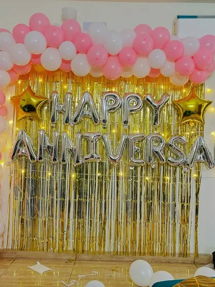 A clear, straight-on view of the pretty pink and gold anniversary backdrop.