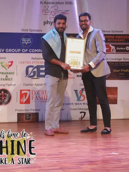 Presenting an award on stage during the showcase. It's a privilege to honor the dedication of our performers and partners.