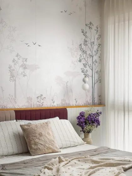 The headboard in this guest room is set against a delicate pastel wallpaper depicting a serene landscape. The contrasting deep red of the headboard adds a soft touch of color and character.