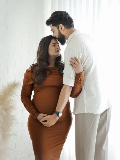 Capturing the gentle moments of affection. This close-up shot focuses on the bond between the couple, making it a cherished memory of their pregnancy journey.