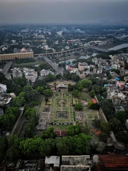 An aerial perspective of Shaniwar Wada, capturing the fort along with the nearby river and bridges, placing the heritage site in its urban context.