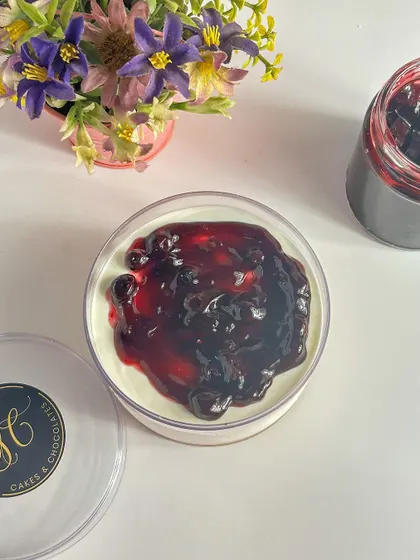 An overhead view of the blueberry cheesecake tub, showing the generous amount of fruit topping. Every spoonful is a perfect bite.