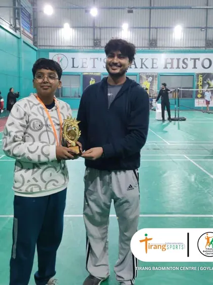 A proud winner with his trophy at the Shuttle Shufflers tournament. The smile on his face says it all. This is why we do what we do.
