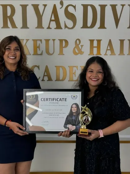 A moment of achievement. This student is now a certified makeup and hair artist.