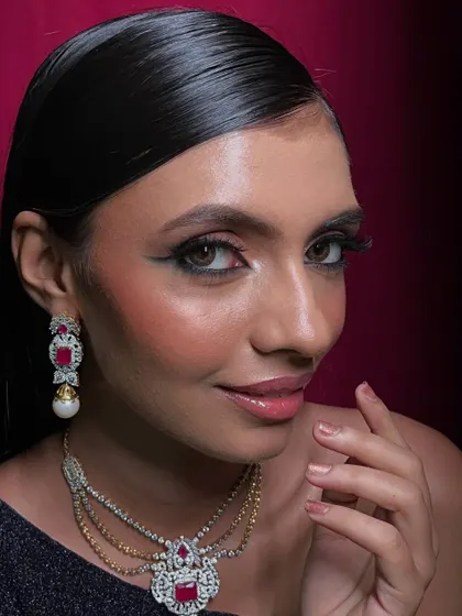 A confident, direct-to-camera pose that captures the full essence of this red carpet-ready makeup.