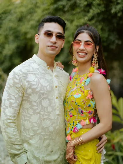 A stylish couple portrait. They both look ready to party, with the bride rocking a colorful and modern pre-wedding look.