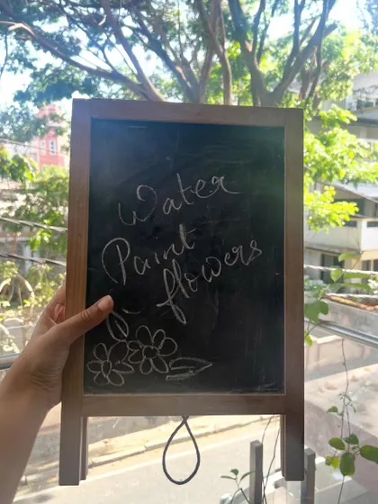 Today's theme is "Water Paint Flowers". We love using our little chalkboard to introduce the art project for the day.