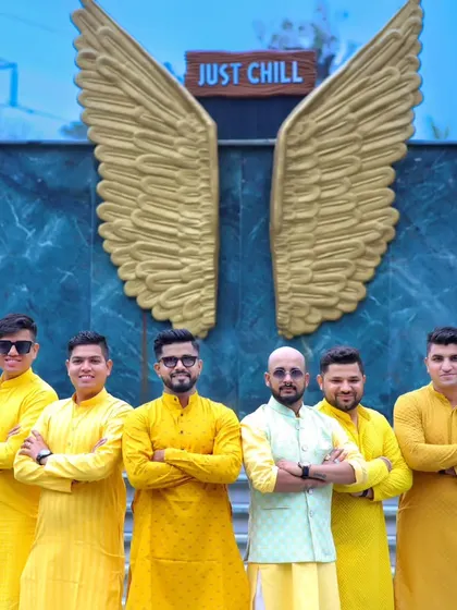"Find your tribe, and love them hard." The groom and his groomsmen pose for a cool group photo in their matching yellow Haldi outfits.