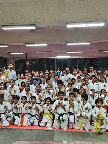 A large group photo of all the students who won medals at the State and International Karate Tournament. Every student is a champion in their own right.