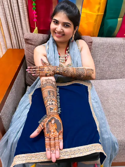 A happy client showing her single-hand portrait mehndi. This is a great option if you want a detailed design on just one arm.