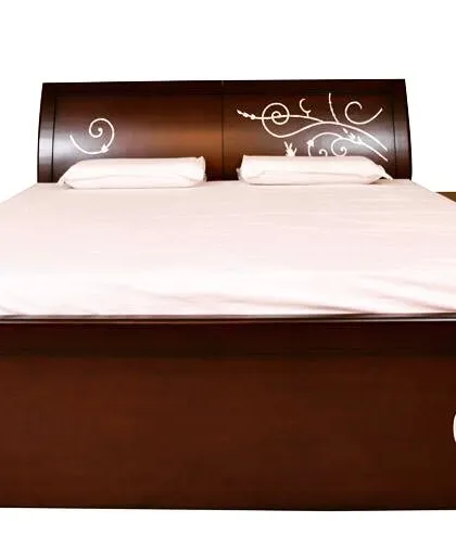 This wooden bed features a simple, modern design elevated by delicate white inlay work on the headboard and footboard. It's a subtle artistic touch that adds a unique character to the piece.