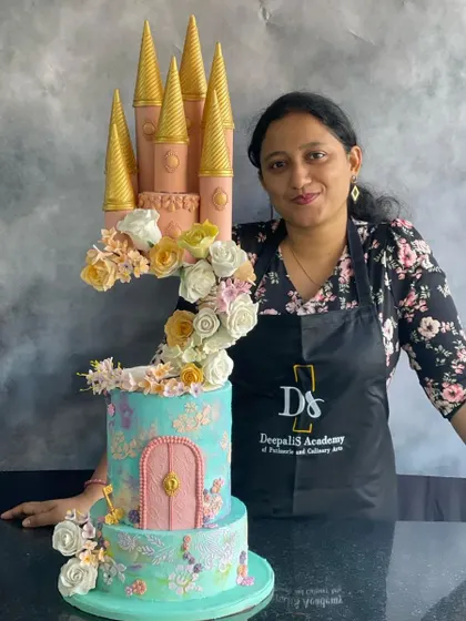 Me with our dreamy floral castle cake, a buttercream creation that was a pleasure to work on with my fellow cake artists.