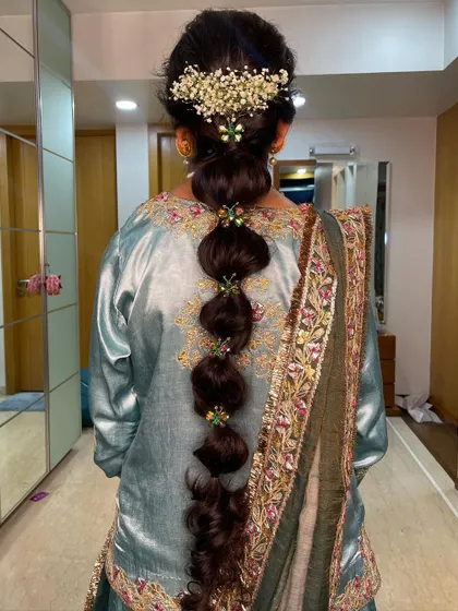 A beautiful, long balloon braid created for a Mehendi ceremony. I adorned it with colorful accessories and fresh baby's breath for a festive look.