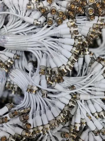 A large pile of white video and power baluns for use with CAT6 cable.