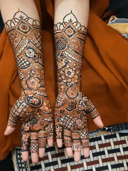 A stunning full coverage design for an engagement bride. The mix of floral and geometric patterns creates a rich and celebratory look.