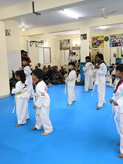 I instruct a class of beginners on their basic stance.