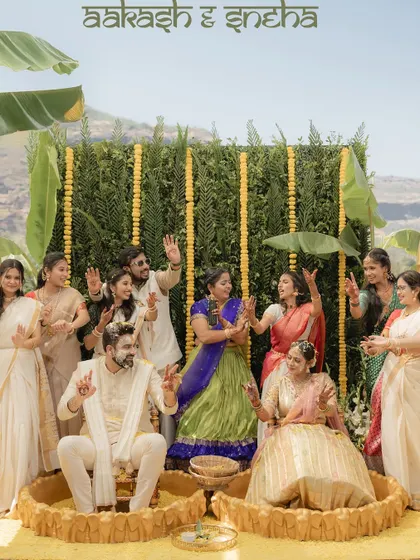 The whole family joins in the fun! A lively group photo from a vibrant outdoor Haldi ceremony.