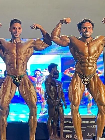 Two champions posing together on stage.