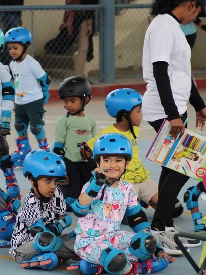 A moment of rest and instruction during a busy class. We teach kids to sit down safely on their skates and listen, ensuring our sessions are organized and productive.