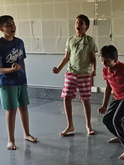 A duplicate image of three boys in a theatre exercise.