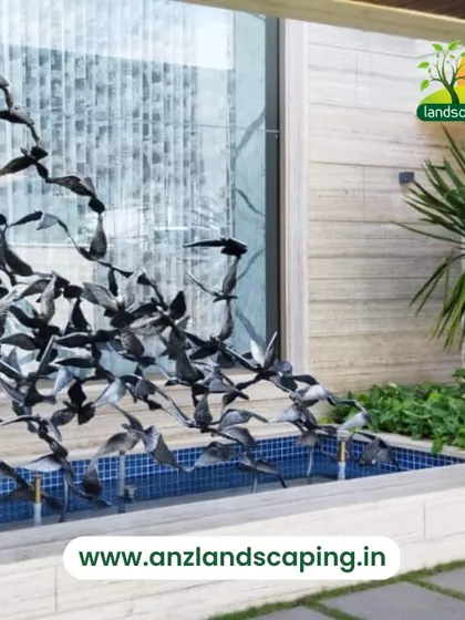 A dynamic and modern water feature with a sculpture of birds in flight, adding a sense of movement and artistry to the landscape design.