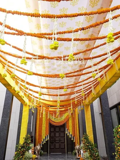 Looking up at the entrance canopy, you can see the detailed fabric work and hanging floral strings. This design element created a beautiful overhead texture and continued the vibrant color scheme throughout the space.