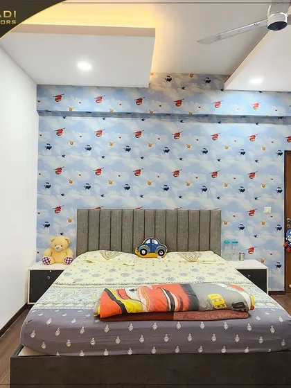 A child's bedroom with a playful hot-air balloon themed wallpaper. The simple yet comfortable furniture makes it a perfect space for a young one to grow.