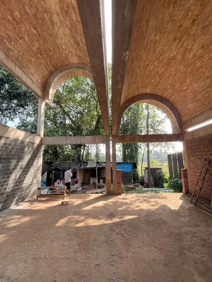The double-vaulted space of the House of Verses, open to the elements during construction. This photo captures the powerful sense of volume and connection to the landscape that is central to the design.