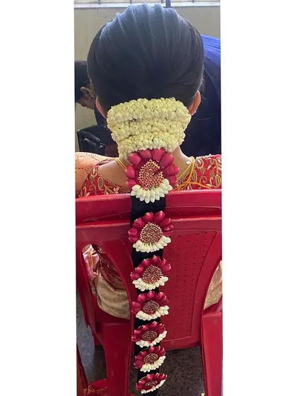 A beautiful floral jada for a muhurtham. This braid is decorated with fresh jasmine and intricate floral pieces made from rose petals, offering a fragrant and colorful alternative to metal jewellery.