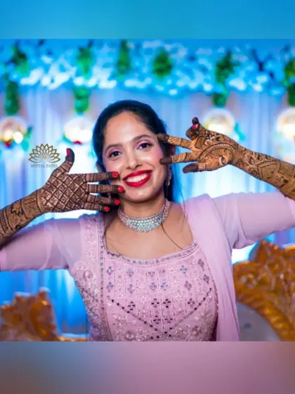 A playful and happy bride, her mehndi-adorned hands adding to her joyful expression. It’s wonderful to see my clients so happy with their designs.