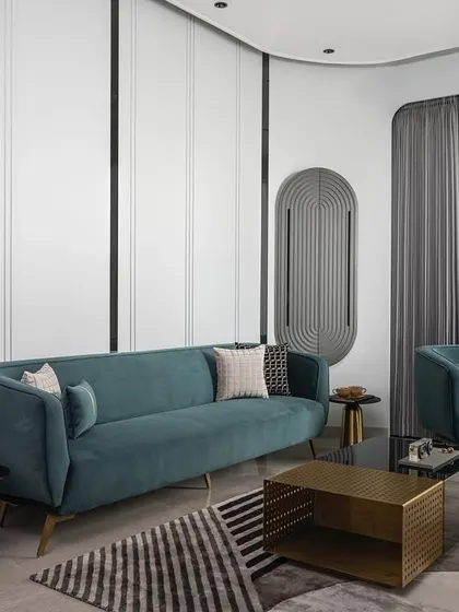 Another view of the living area, highlighting the curved wall details and the interplay of light and shadow. The layout is designed for both relaxation and social gatherings, making it a versatile and stylish heart of the home.