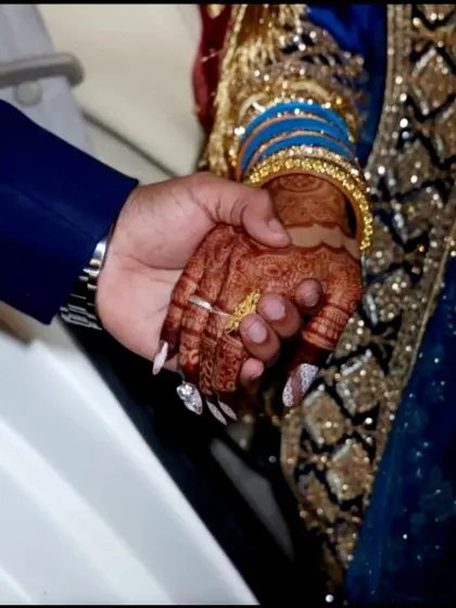 A touching moment between the bride and groom, highlighting her beautiful henna stain. This is the color that makes every bride feel special.