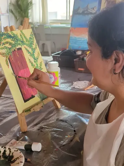Another participant enjoying the process of painting a rustic door. The concentration and joy are evident.