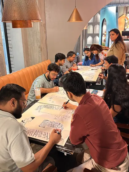 A wider view of the Google team engrossed in the doodling workshop. I love facilitating these sessions and watching colleagues interact and create in such a relaxed, informal setting.